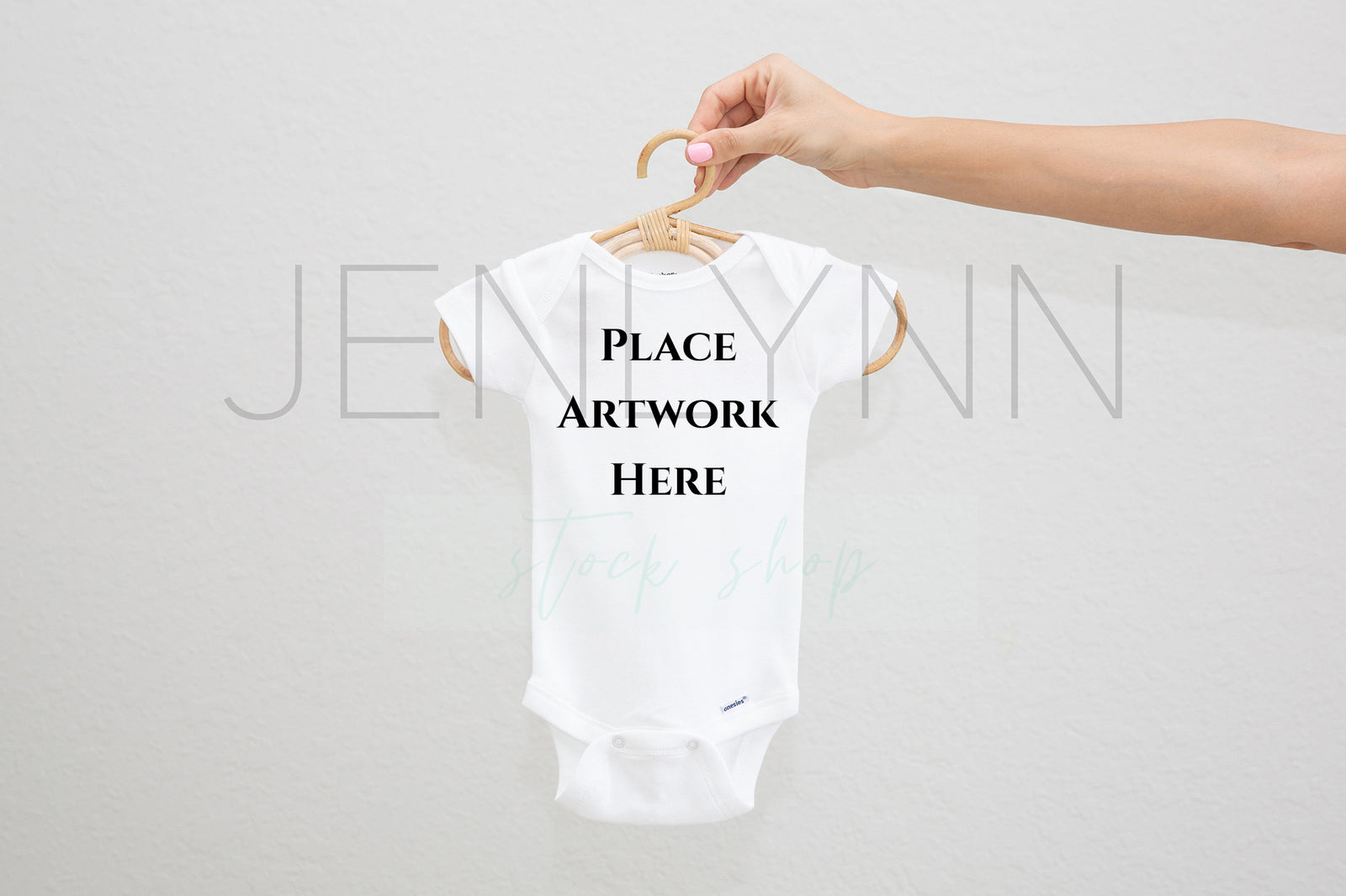 Woman Holding White Onesie on hanger Mockup #5 JPG